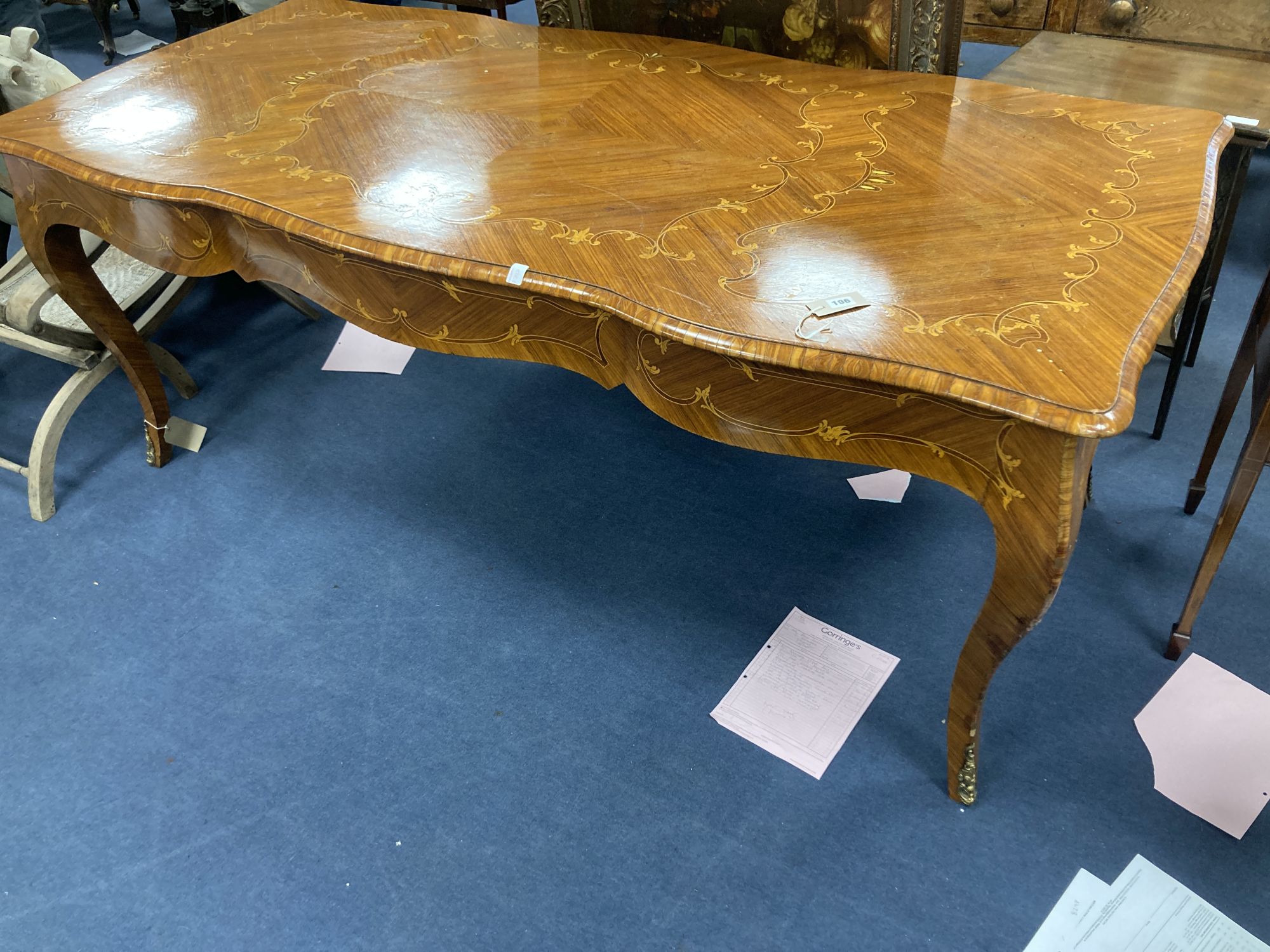 A Louis XVI design marquetry inlaid kingwood serpentine centre table, width 196cm depth 90cm height 79cm